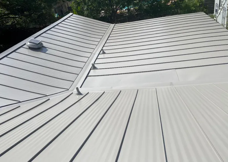 Solar attic fan installed on a metal roof for Roof Ventilation in Dale City